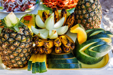 Fresh tropical fruits on the beach. Fresh tropical fruits on the table. The concept of relaxation. Healthy eating.