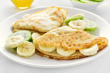 Crepes with banana and kiwi slices