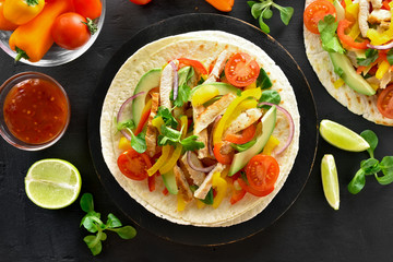 Tacos with chicken meat and vegetables