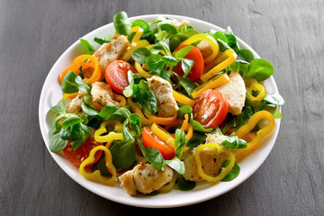 Vegetable salad with pieces of chicken meat