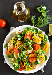 Vegetable salad with pieces of chicken meat