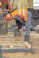 Khimki, Russia - June 14, 2018: Worker at the construction site sawing