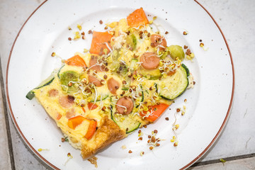 Omelet with sausages and vegetables