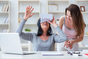 Senior woman experiencing virtual reality glasses