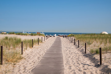 Fototapeta na wymiar Boardwalk leading to beautiful white sand beach