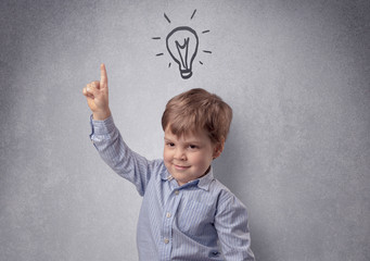 Smart little junior in front of a drawn up grey wall with childlike concept