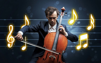 Young handsome cellist playing with music sheet background