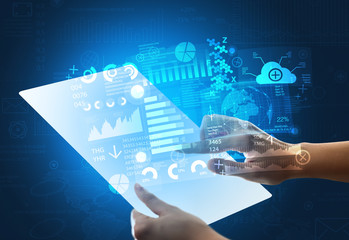 Young female hand holding a tablet with blue graphs 