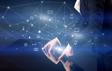 Male hands touching interactive table with blue mixed communication icons in the background