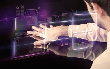 Male hands touching interactive table with purple cloudspace graphic on it 