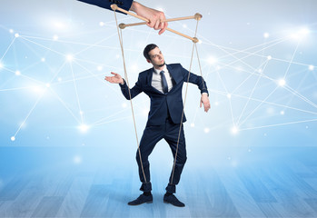 Puppet businessman controlled by another hand with financial concept

