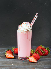 Delicious strawberry milkshake decorated with whipped cream