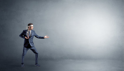 Small karate man fighting in an empty grey copy space