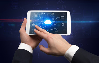 First person view of a hand using tablet with cloud office concept
