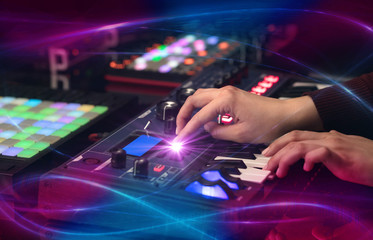 Fototapeta na wymiar Hand mixing music on dj controller with wave vibe concept