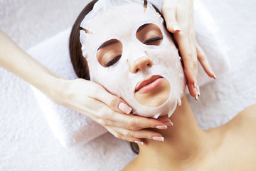 Beauty and Care. Beautiful Young Girl with Mask in Spa Salon. Spa Therapy. High Resolution