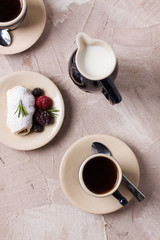 Two coffee cup roll with cream and berries milk