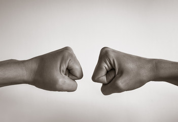 closeup of two hands bumping their fists.
