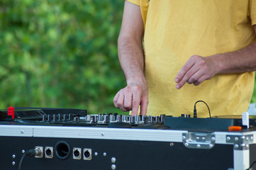 closeup of hands of mixer at dance floor in outdoor