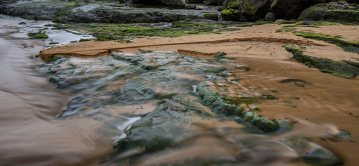 Green rocks, sand & water