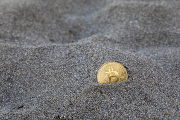 Single Bitcoin in Sand