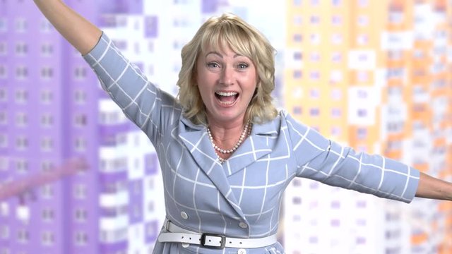 Excited woman celebrating victory. Happy mature woman clenching her fists in excitement. Human expresion of victory.