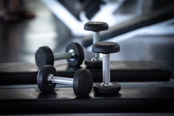 Close up of modern dumbbells equipment in the sport gym , gym equipment concept.