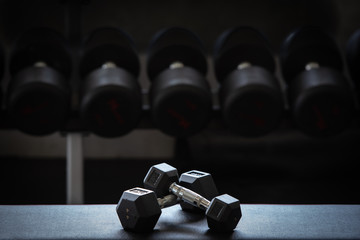 Close up of modern dumbbells equipment in the sport gym , gym equipment concept.