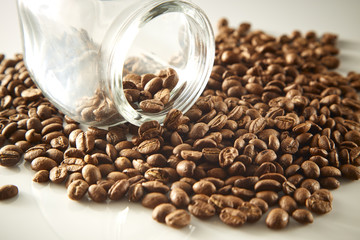 roasted coffee beans poured from clear glass