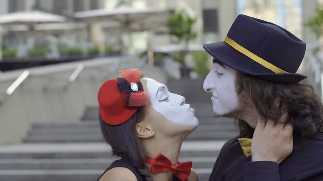 Young in love mimes kissing each other