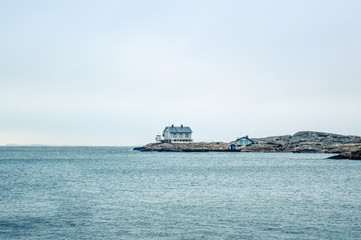 Tiny blue lighthouse on swedish coastline