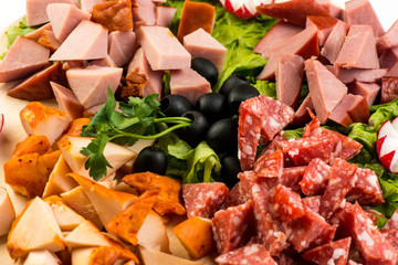plate Board with meat and cheese. The Banquet in the Italian style.