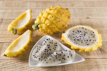yellow pitahaya dragon fruit on wooden background