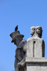 statue of a man with a top hat with a bird perched on his hat, Rome Italy