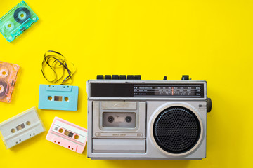vintage radio and cassette player on yellow background, flat lay, top view. retro technology - obrazy, fototapety, plakaty