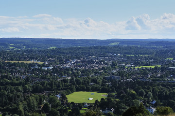 View from hill suburbs of London, United Kingdom. Green trees, small houses, meadows and lawns....