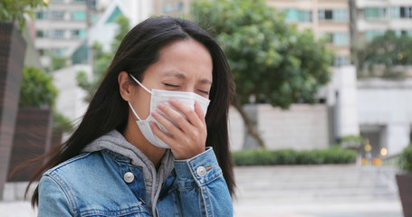 Fototapeta premium Woman coughing with wearing face mask at outdoor