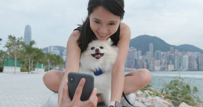 Woman taking selfie with her dog at outdoor