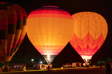 Hot air balloons glowing at night