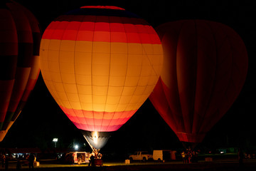 Hot air balloons glowing at night