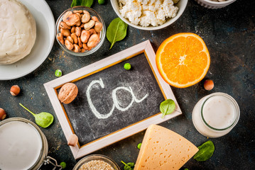 Healthy food concept. Set of food rich in calcium - dairy and vegan Ca products, dark blue background copy space