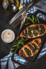 Healthy dinner, Pollo a fisarmonica con ricotta e spinaci, chicken fillet baked with cheese and spinach. On grill pan, with sauce and fresh vegetables.  top view