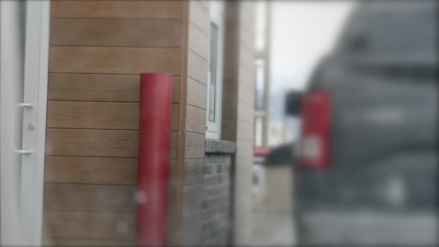 Car waits in fast food drive through POV from other car