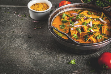 Indian food recipes, Indian Omelet Masala Egg Curry, with fresh vegetables - tomato, hot chili pepper, parsley dark stone background, copy space