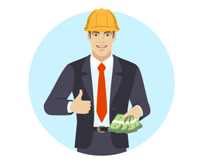 Businessman in construction helmet with cash mone showing thumb up