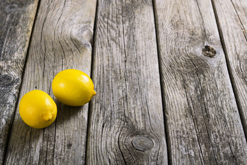 two lemons on old wood table