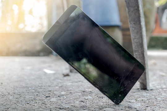Cell phone falls crashing to the concrete floor.