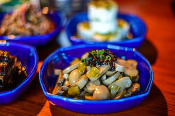 Assortment of Classic Northern China Cold Appetisers in fine-dining restaurant: button mushrooms are accentuated with Chinese truffle.