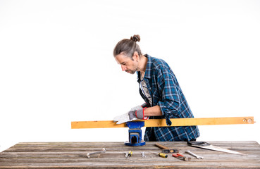 worker in blue  shirt working with wood