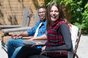 man and woman laughing outside